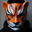 3D printed tiger shinobi mask with feline stripes, pointed ears and samurai-inspired contours.