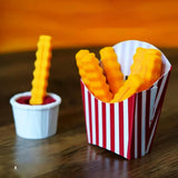 Colorful 3D-printed French fry clips in a fun striped container.