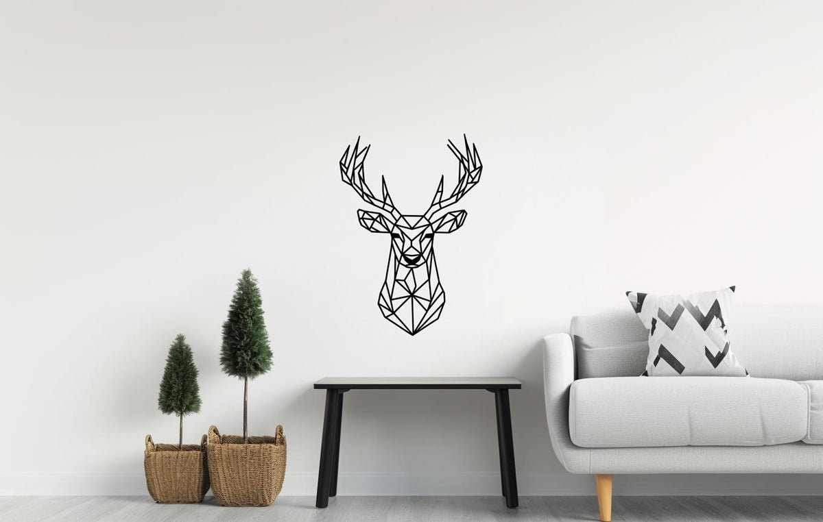Geometric deer wall decal art displayed on a minimalist living room wall with plants and modern furniture.