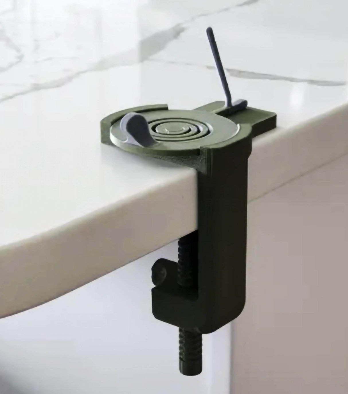 Compact clamp for securing objects to a table.
