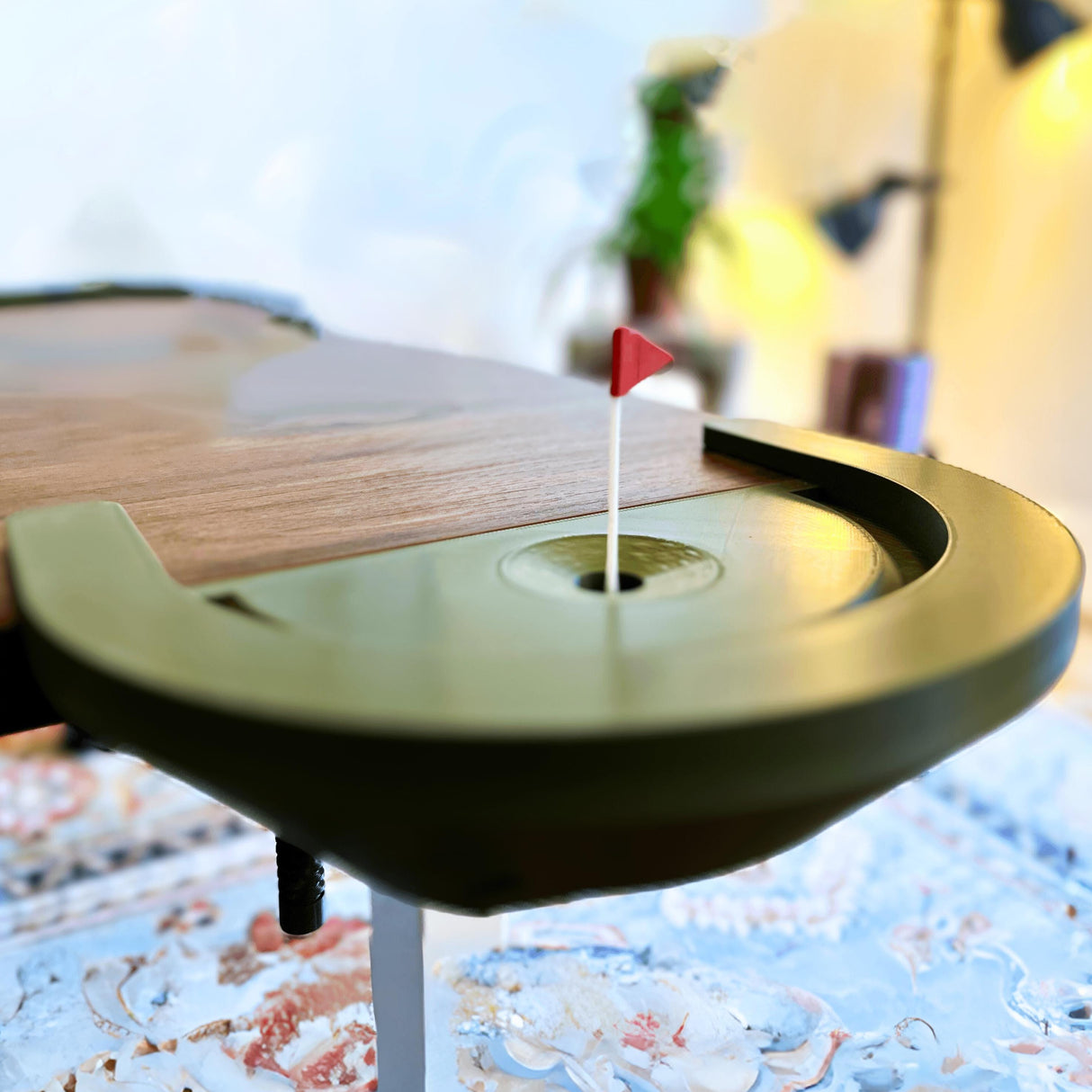 Close-up of a mini golf putting green with a red flag.