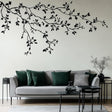 Minimalist Black Branch Wall Decal displayed in a room setting.