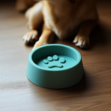 3D-printed dog bowl with raised paw print design.