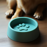 3D printed modern dog bowl in teal with raised paw print design.