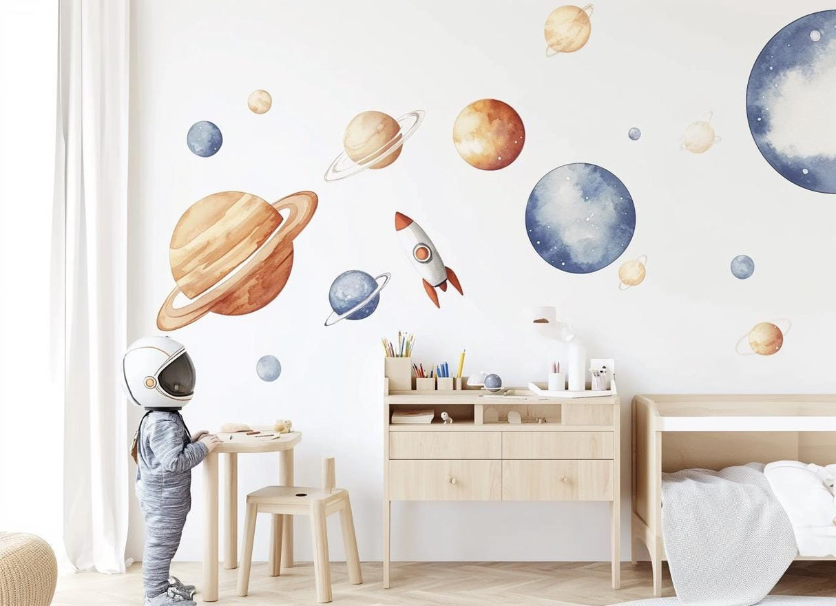 A child’s room with XXL watercolor wall decals of the solar system, including planets, stars, and a rocket.