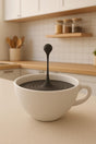 3D printed floating coffee-drop sculpture with a suspended droplet above a small cup.
