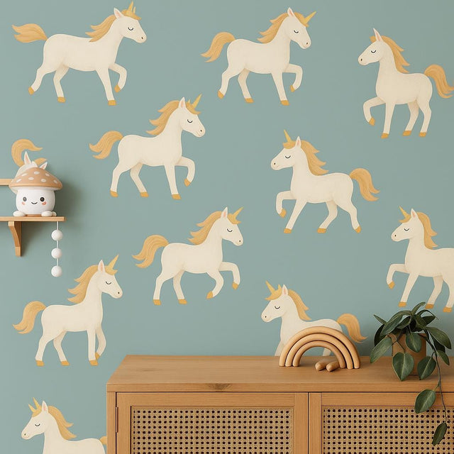 A nursery wall featuring twelve pastel unicorn decals with golden manes and horns arranged over a teal background.