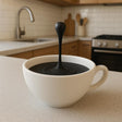 Compact 3D printed floating coffee-drop illusion with a suspended droplet above a small cup.
