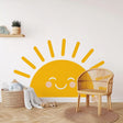 Smiling sun wall decal in a nursery, bright yellow with cheerful facial features.