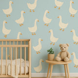 A nursery wall decorated with twelve large cream-colored goose decals, arranged evenly on a soft blue wall.