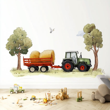 A playful wall decal featuring a green farm tractor pulling a trailer with hay bales between two trees.