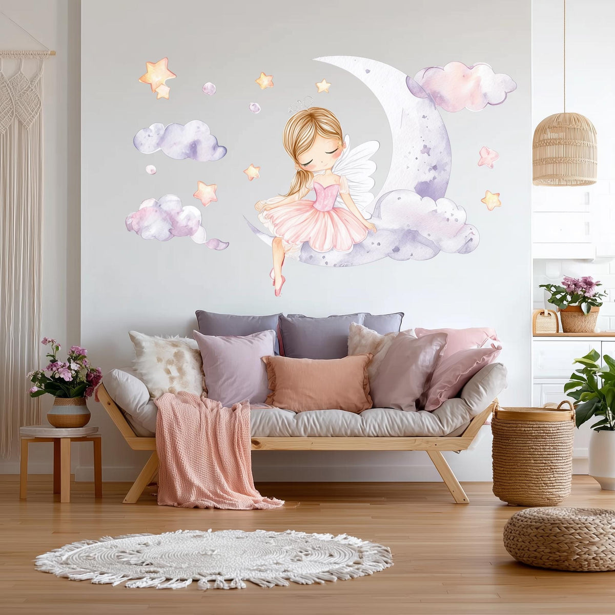 A whimsical wall decal showing a blonde fairy ballerina in a pink dress sitting on a crescent moon.