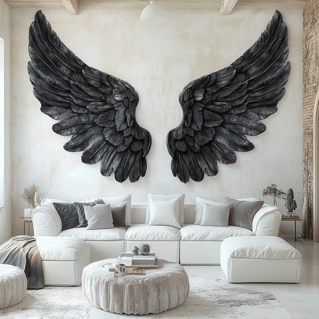 Large black angel wings wall decal applied to a living room wall above a white sectional couch.