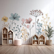A stylish children's room with pastel-colored floral line art wall decals behind toy shelves.