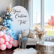 A party backdrop featuring a pastel balloon arch in pink, blue, and silver.