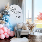 A party backdrop featuring a pastel balloon arch in pink, blue, and silver.
