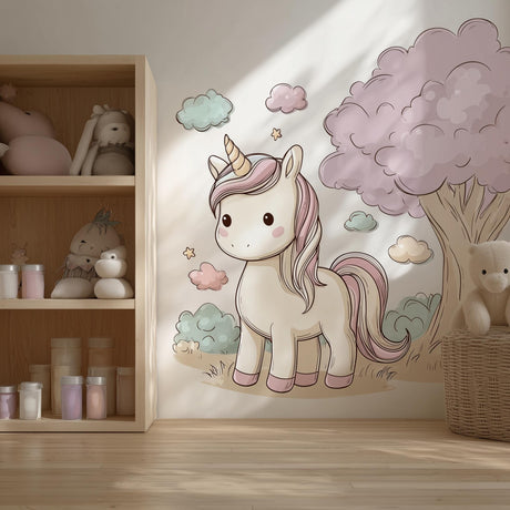 A cozy children’s room with a large wall decal of a pastel cartoon unicorn beside a fluffy pink tree.