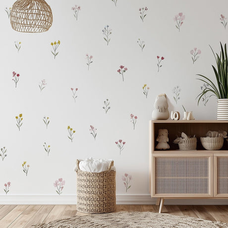 A softly lit nursery room featuring individually placed watercolor-style flower decals in pastel pink, yellow.
