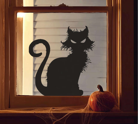 Vinyl window decal of a scary black cat silhouette with pointed ears and glowing eyes, placed on a window.