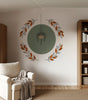 Vinyl wall decal featuring a hanging plant centered over a green circle, framed by terracotta and beige botanical branches.