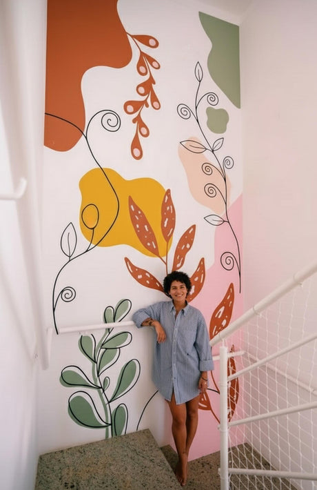 Large abstract botanical wall decal with colorful shapes and flowing lines applied to a staircase wall.