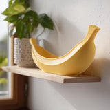 Yellow 3D printed banana-shaped catchall bowl with a curved boat-like form.