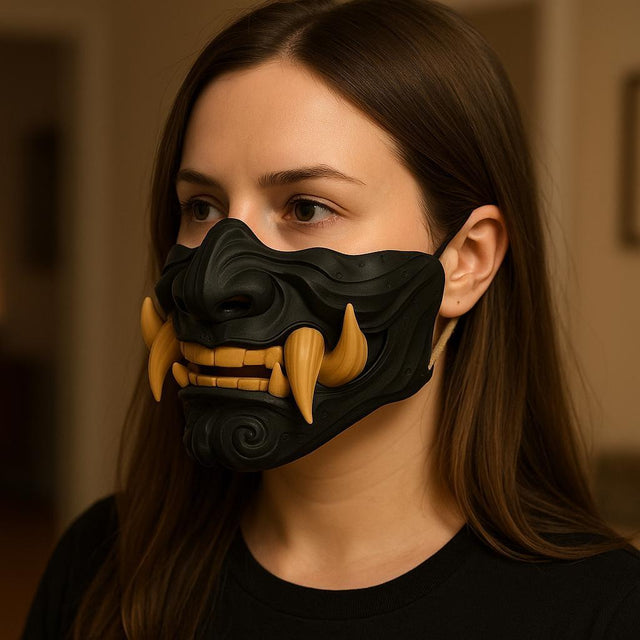 A woman wearing a 3D printed Half Oni Mempo Mask featuring a black sculpted face with fierce golden tusks, for cosplay.