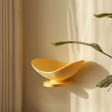 3D printed wall-mounted shelf shaped like a shallow yellow bowl and matte PLA texture.
