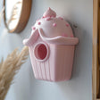 3D printed wall hanging shaped like a cupcake-style birdhouse.