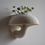 3D printed wall-mounted mushroom planter shelf in matte light PLA with finely ribbed cap and gills.