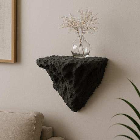A black 3D printed wall-mounted shelf with a rugged, rock-like texture and triangular shape.