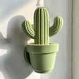3D printed cactus-shaped wall decor made from matte PLA plastic, minimalist design inspired by nature.