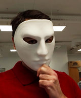A matte white 3D printed full face mask with detailed swirl patterns near one eye.