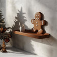 3D printed wall shelf shaped like a gingerbread man.