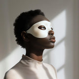 Adult person wearing a minimalist white 3D printed eye mask.