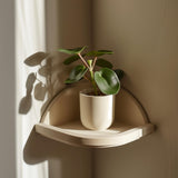 3D printed minimalist corner wall shelf in a soft neutral color and matte PLA texture.