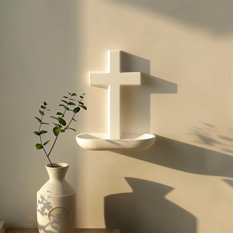 3D printed minimalist cross wall shelf in matte light PLA, with a small rounded ledge below the cross.