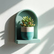 Small arched 3D printed meditation wall shelf holding a potted plant.