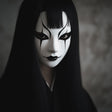 3D printed Japanese Onryo ghost mask with a pale expression and narrow eye openings.