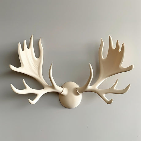 3D printed wall decor shaped like stylized cream-colored moose antlers in three pieces (two antlers and a round base).