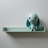 3D printed wall shelf with an integrated bunny character and a small plant pot beside it.