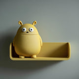 3D printed wall shelf with a tray-style ledge and a round monster container whose head lifts off for storage.