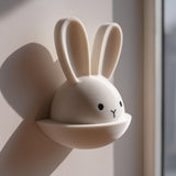 3D printed wall decor shaped like a bunny head with long ears and a small semicircular pocket below.