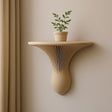 A sculptural wall-mounted shelf in matte beige, 3D printed with elegant vertical ribbing.