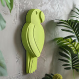 3D printed wall decor shaped like a minimalist parrot silhouette in a bold green color.