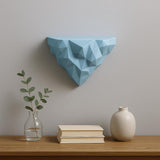 Geometric 3D printed blue wall shelf with a polygonal faceted design.
