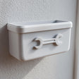 3D printed wall-mounted organizer bin with an embossed wrench icon.