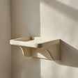 3D printed wall shelf with an asymmetrical curved support and a compact display ledge.