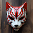 3D printed Japanese fox warrior mask with pointed ears and sculpted samurai-style details.