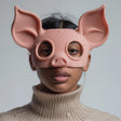 3D printed pig face mask with soft rounded design and large ears, worn by an adult model indoors.
